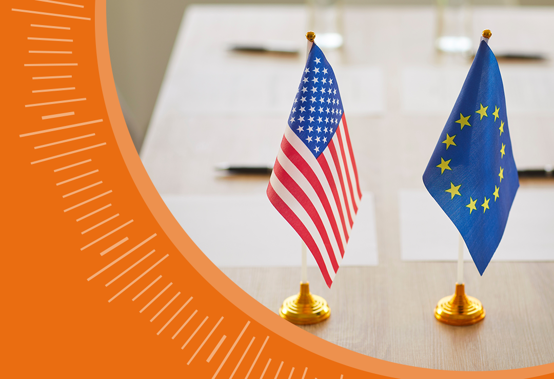 United States and European Union flags standing side by side indoors
